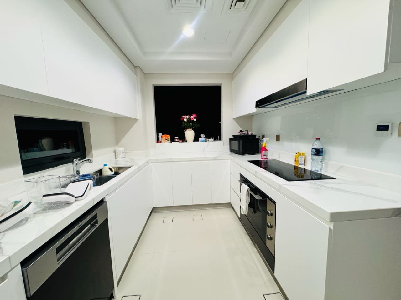 White wrapped kitchen with modern appliances – Floor Woods Dubai