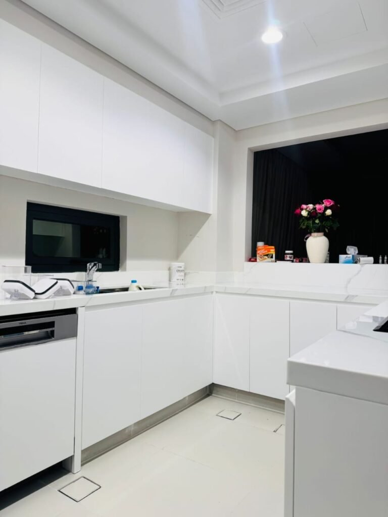 White high-finish wrapped kitchen cabinets – Floor Woods Dubai
