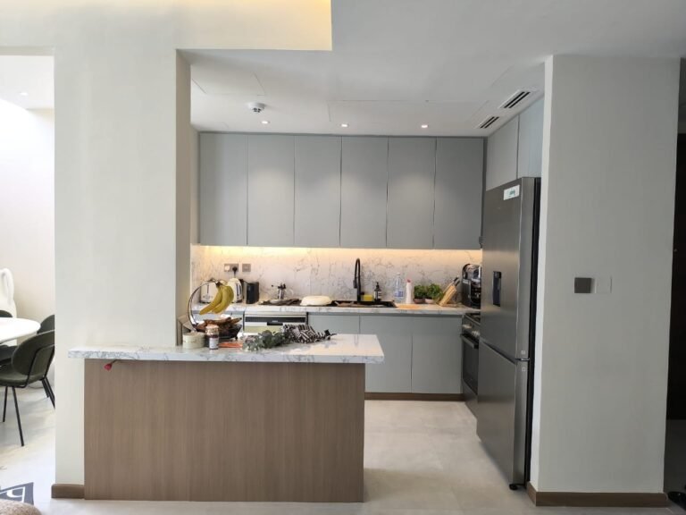 Grey wrapped kitchen with wood-finish island – Floor Woods Dubai
