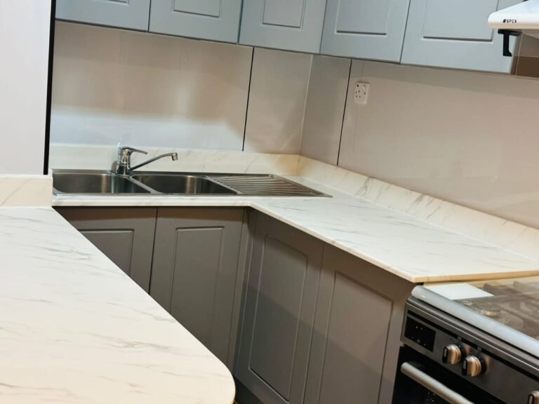 Grey wrapped kitchen cabinets with marble-look counter – Floor Woods Dubai
